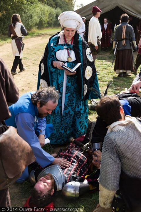 Cardinal Ynez di Caricomare of the Church of the Little Mother ministers to the fallen
