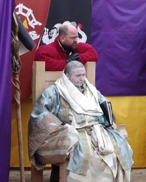 Seated figure in Urizen robes.