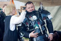 Luke helps Kruger of the Shattered Tower into his armour.