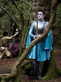 Wide flowing robe in Urizen colours worn under a medium breastplate.