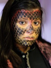 A quick and effective scale effect can be produced using make-up and applied with a stencil.