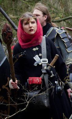 Highborn magister on the battlefield with veil and rod.