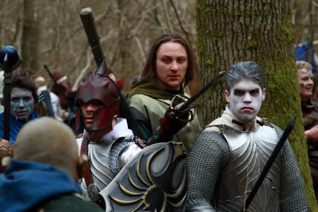 Stylised helm, shield, and breastplates.