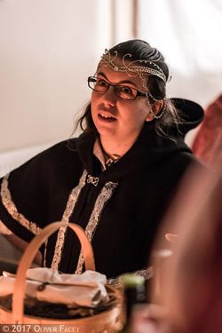 Ornate silver jewelry, and a sumptuous cowl.